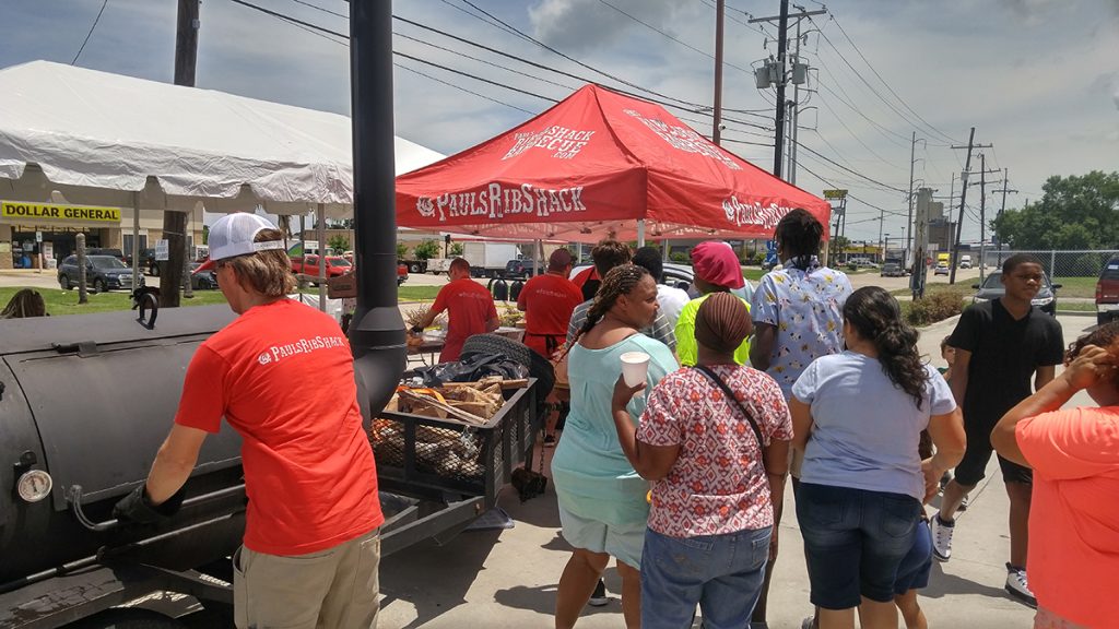 Paul Pettefer Bishop of BBQ serving food at free laundry day in New Orleans